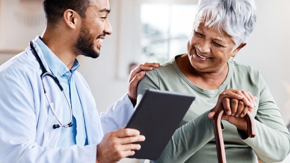 Shot of a young doctor sharing information from his digital tablet with an older patient